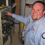 Smiling Man working on a machine