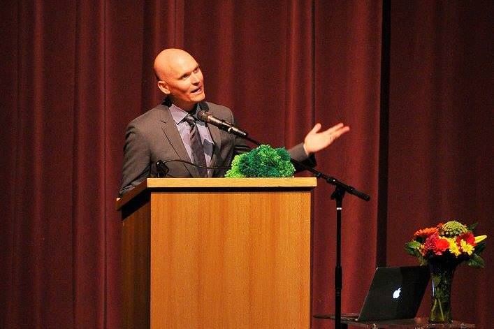 Man in a suit speaking