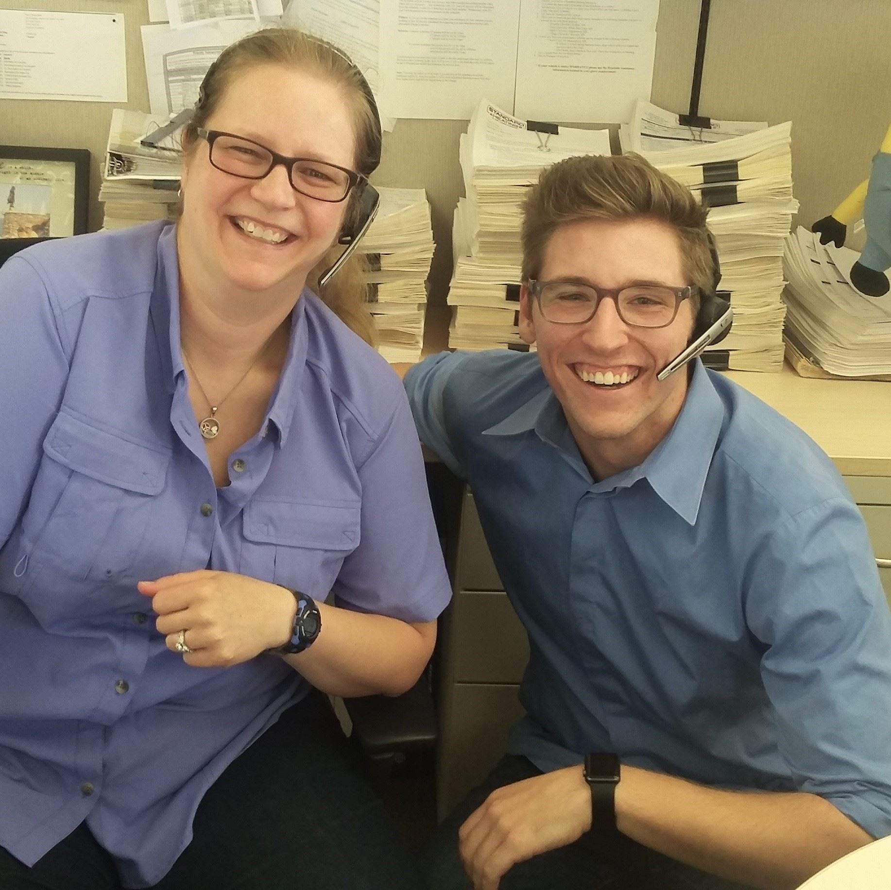 Two employees wearing their headsets